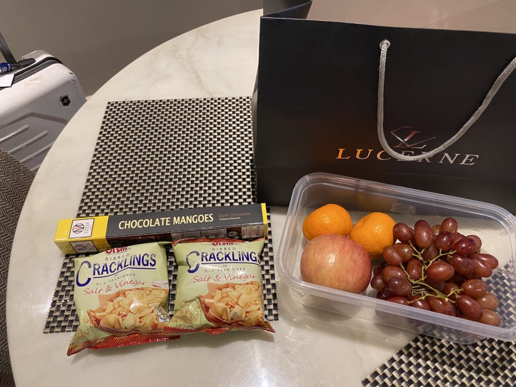 A gift set featuring chocolates and fresh fruits on a table.
