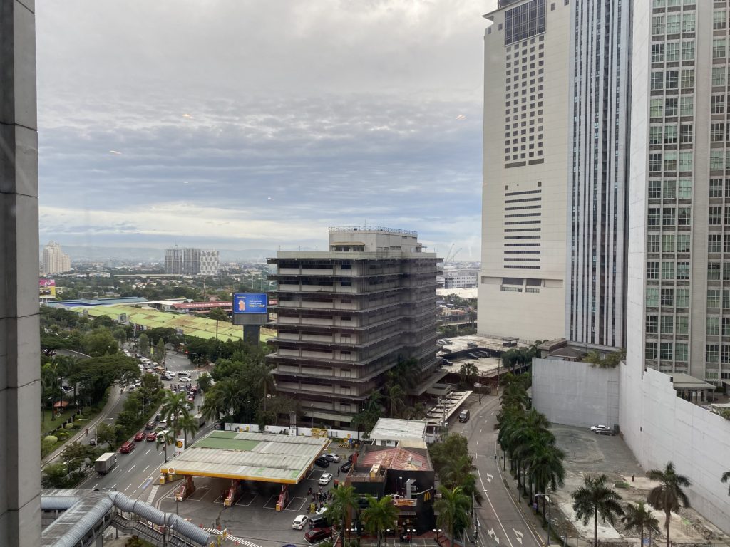 Urban cityscape with modern buildings and a cloudy sky.