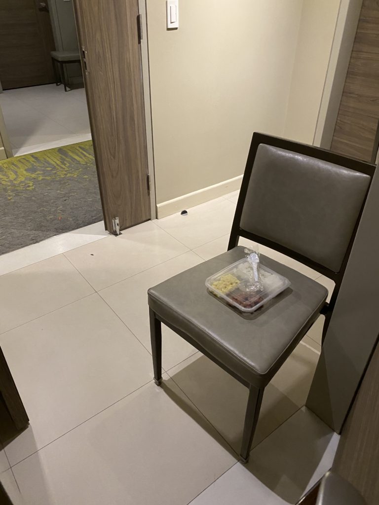 Chair with a book and tissue box in a modern room corner.