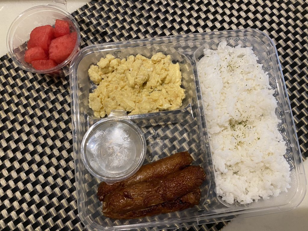 Indian thali with rice, dal, roti, and watermelon.