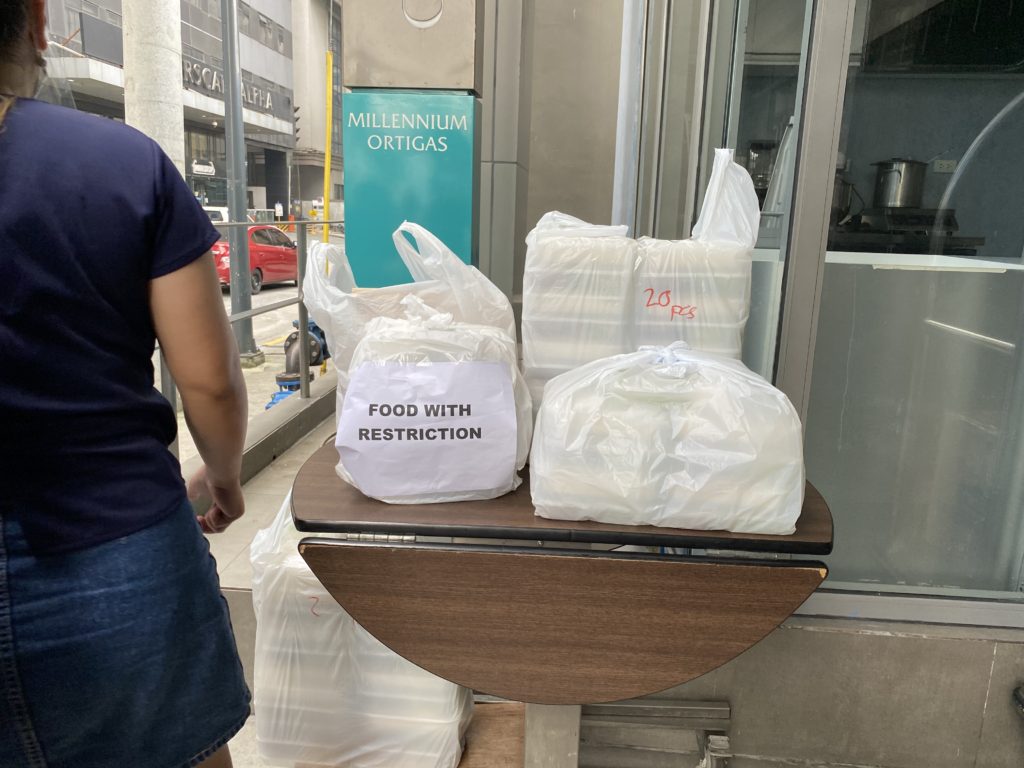 Plastic bags filled with white powder labeled 'Pasta de Coca' on a table.
