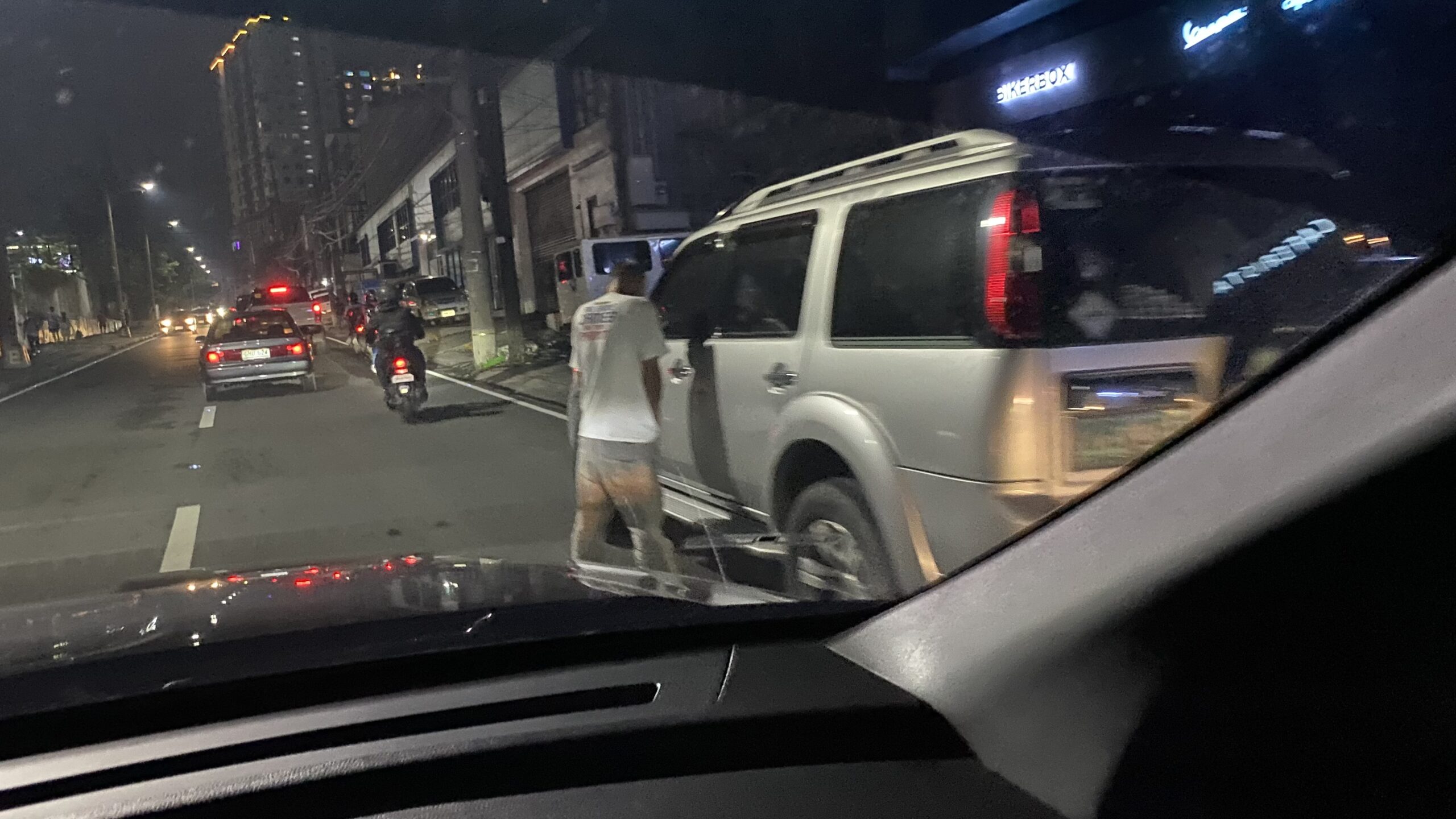 man pees on his vehicle